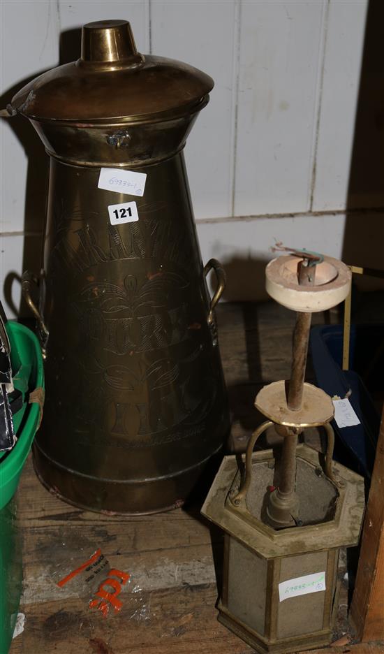 A brass milk churn and lantern light